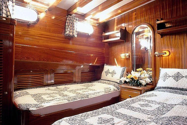 a couple of beds in a room aboard AGANIPPE Yacht for Sale