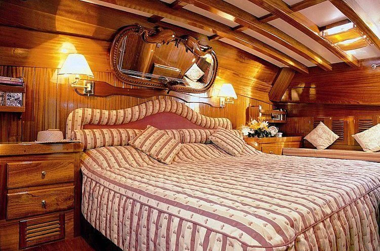 a bed with a large bed aboard AGANIPPE Yacht for Sale