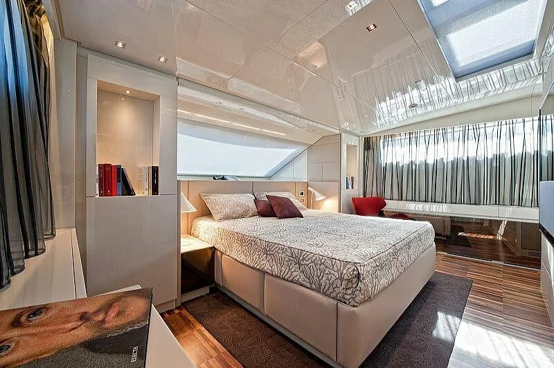 a bedroom with a large bed aboard EMY Yacht for Sale