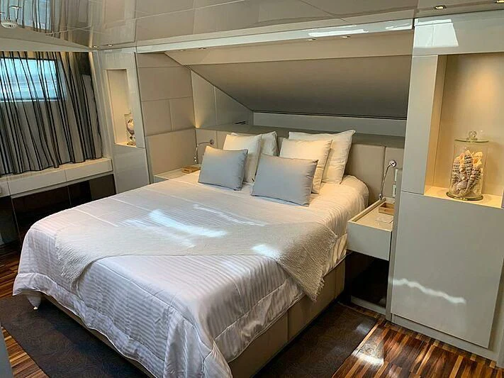 a bed with white sheets aboard EMY Yacht for Sale
