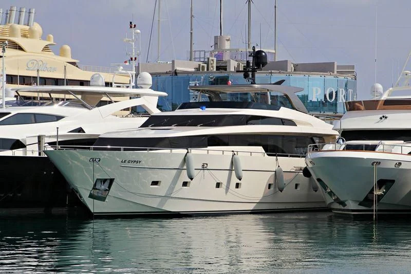 several white yachts in a harbor aboard EMY Yacht for Sale