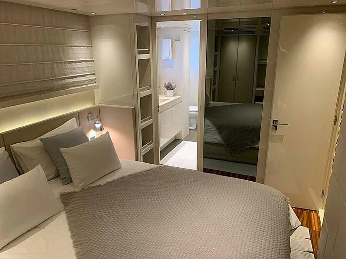 a bed with a white sheet aboard EMY Yacht for Sale
