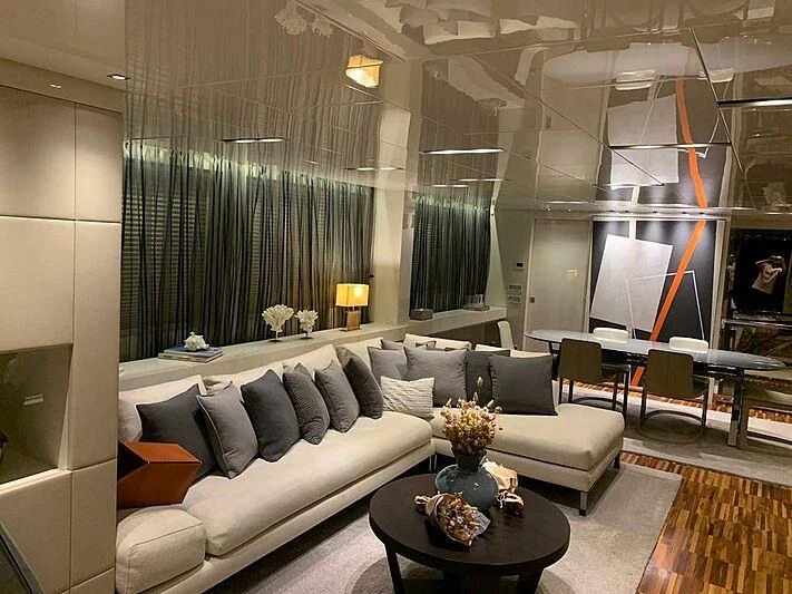 a living room with a large glass wall aboard EMY Yacht for Sale