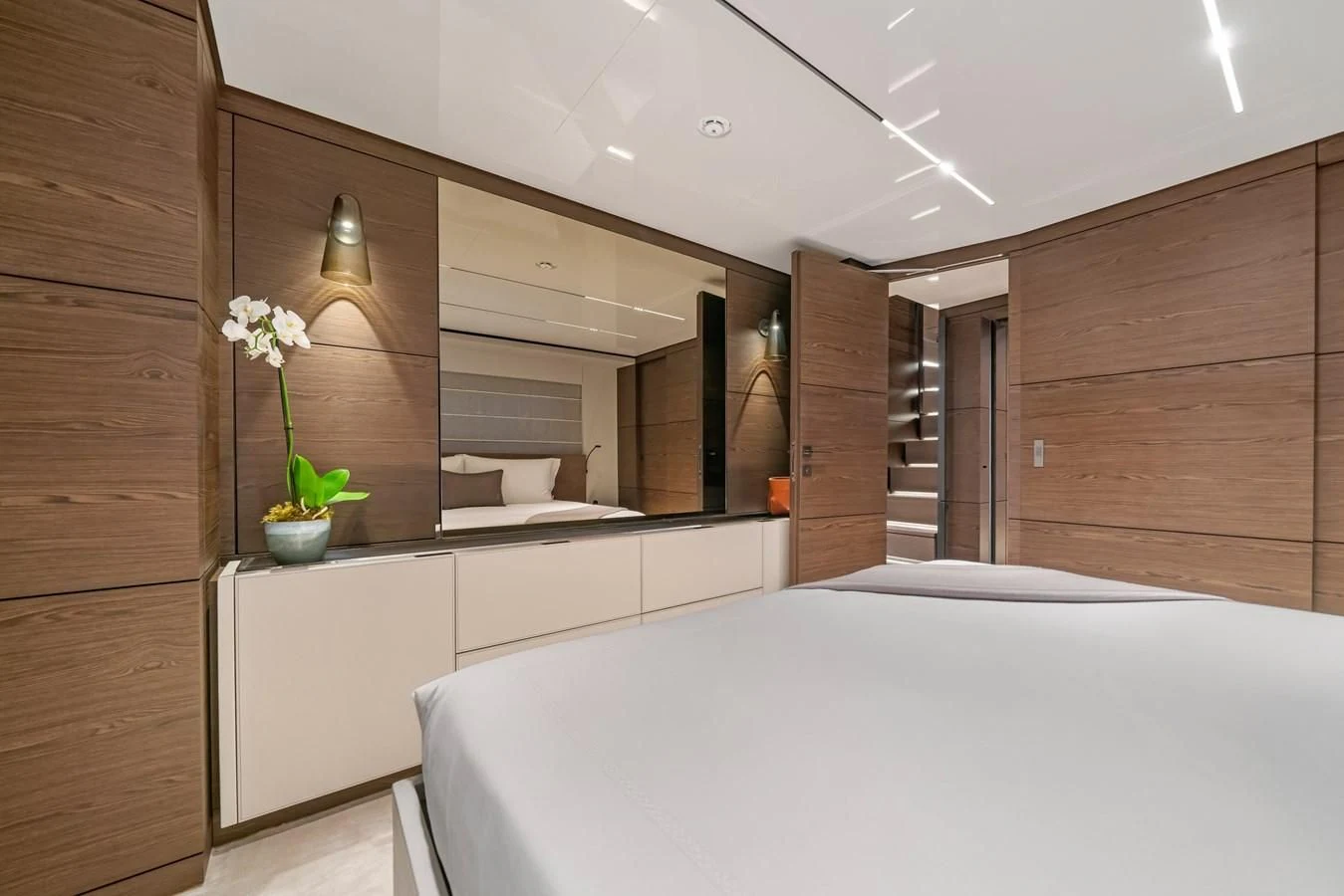 a room with a bed and a mirror aboard ASANTE Yacht for Sale
