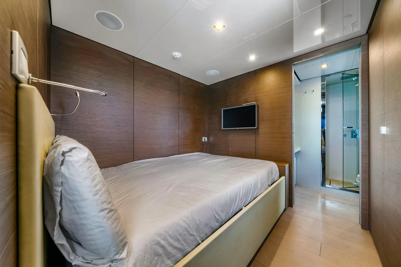 a bedroom with a bed and a television aboard ASANTE Yacht for Sale