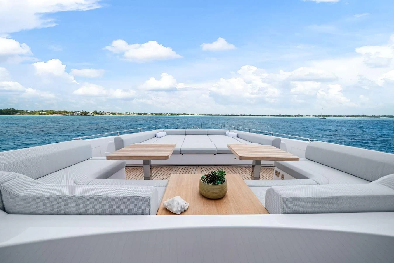 a room with a table and chairs on it by a body of water aboard ASANTE Yacht for Sale
