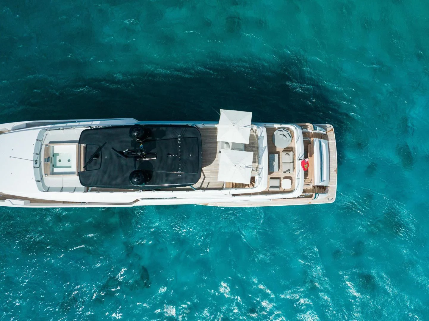 a white ship in the water aboard ASANTE Yacht for Sale
