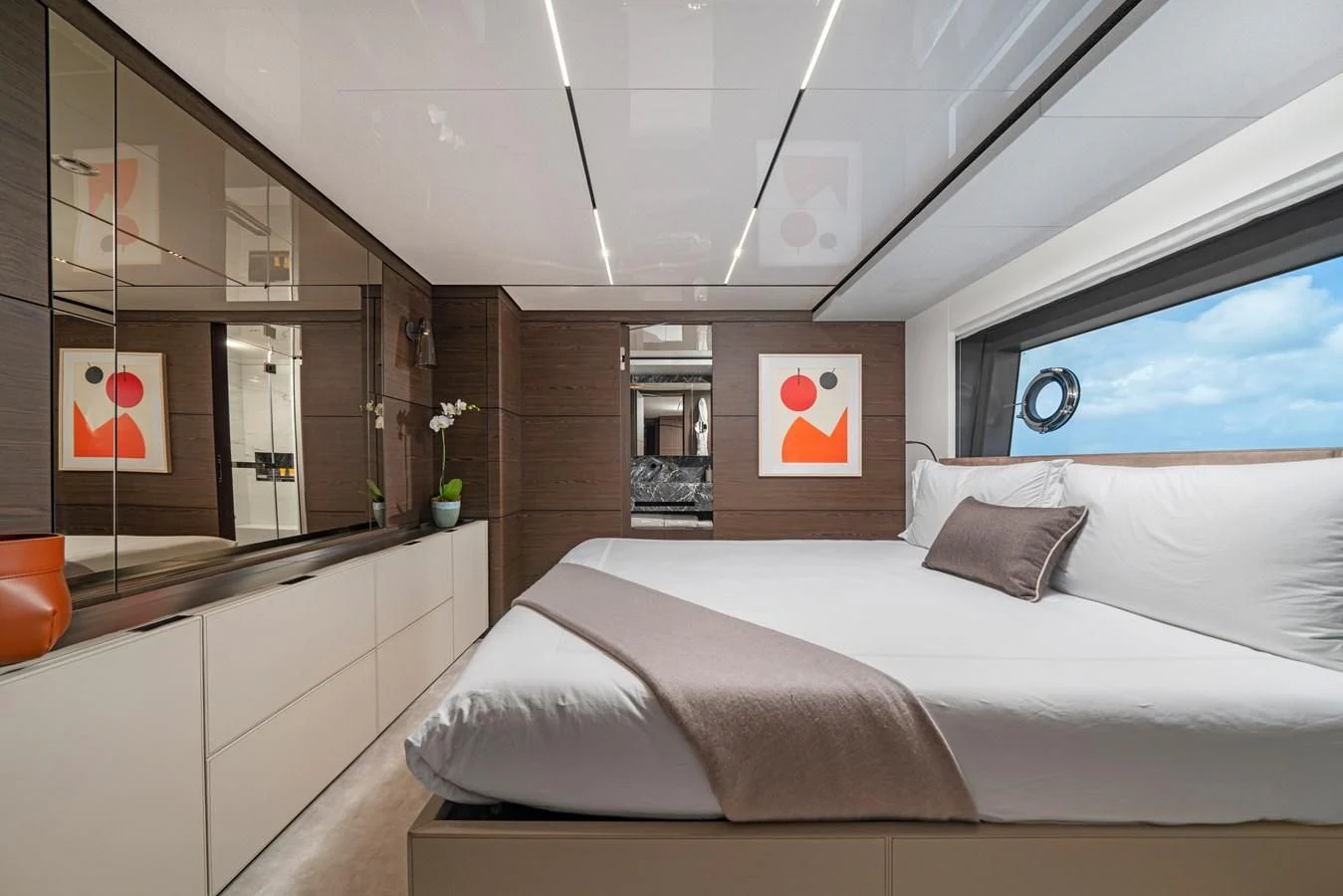 a room with a bed and a mirror aboard ASANTE Yacht for Sale