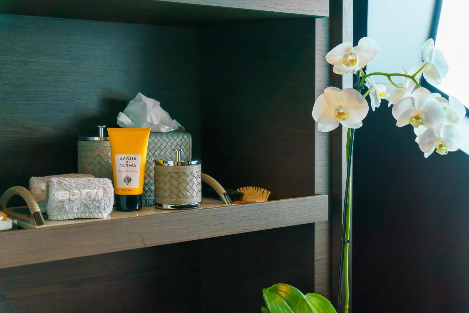 a shelf with a basket and flowers aboard ASANTE Yacht for Sale
