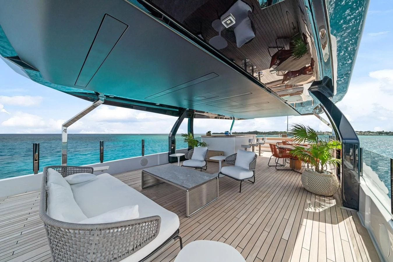 a lounge area on a deck overlooking a body of water aboard ASANTE Yacht for Sale