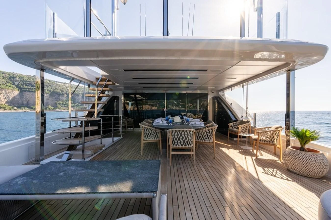 a deck with a table and chairs aboard ASANTE Yacht for Sale