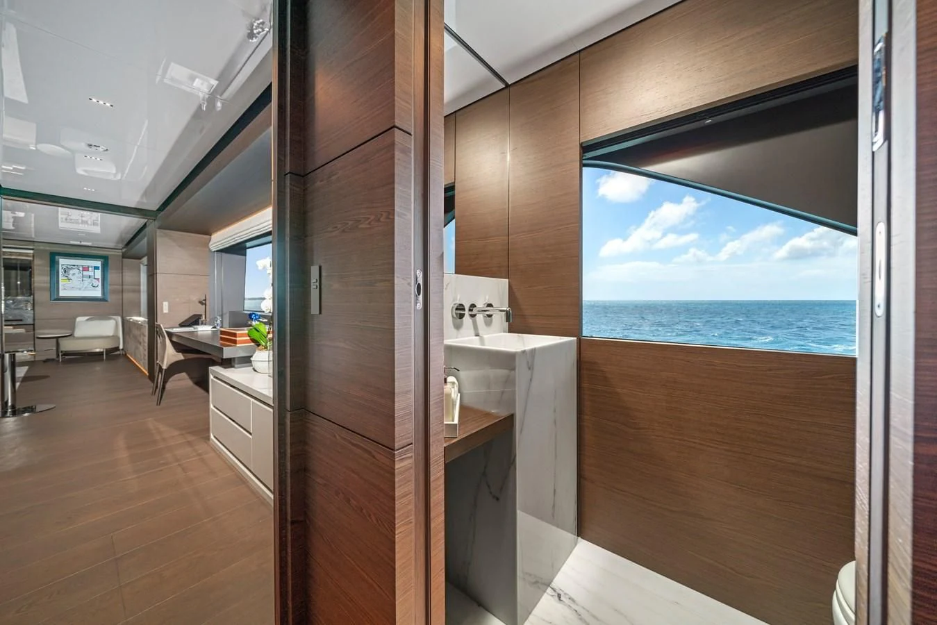 a room with a large window and a view of the ocean aboard ASANTE Yacht for Sale