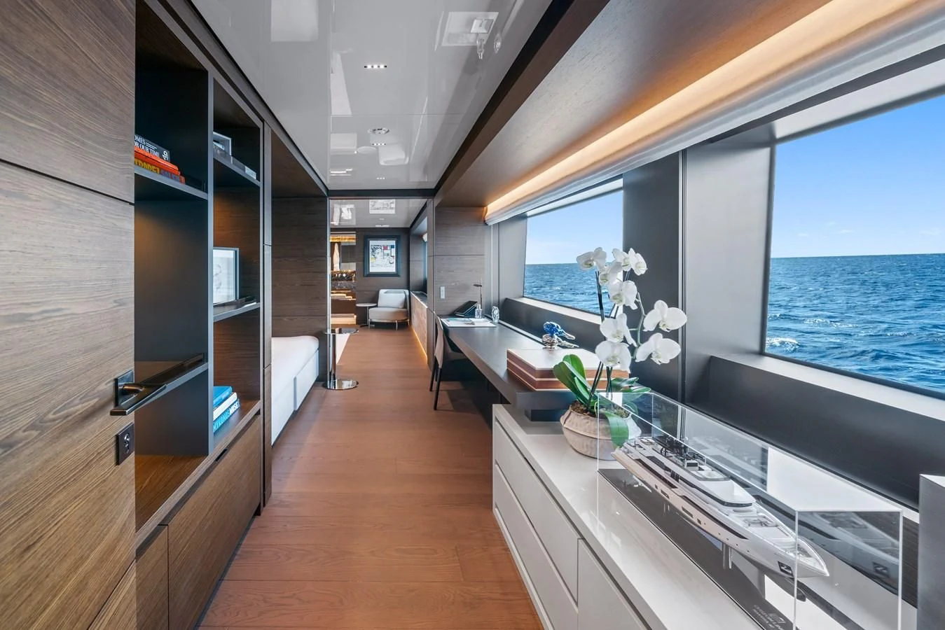 a room with a large window and a table with chairs and a view of the ocean aboard ASANTE Yacht for Sale