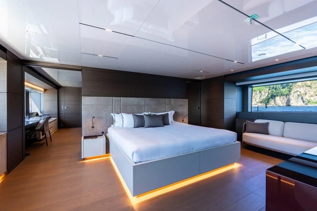 a room with a bed and a couch aboard ASANTE Yacht for Sale