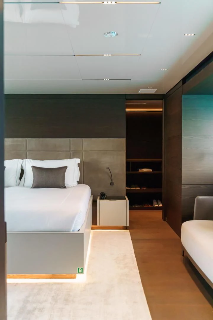 a room with a bed and a couch aboard ASANTE Yacht for Sale