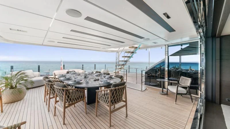 a table and chairs on a deck aboard ASANTE Yacht for Sale