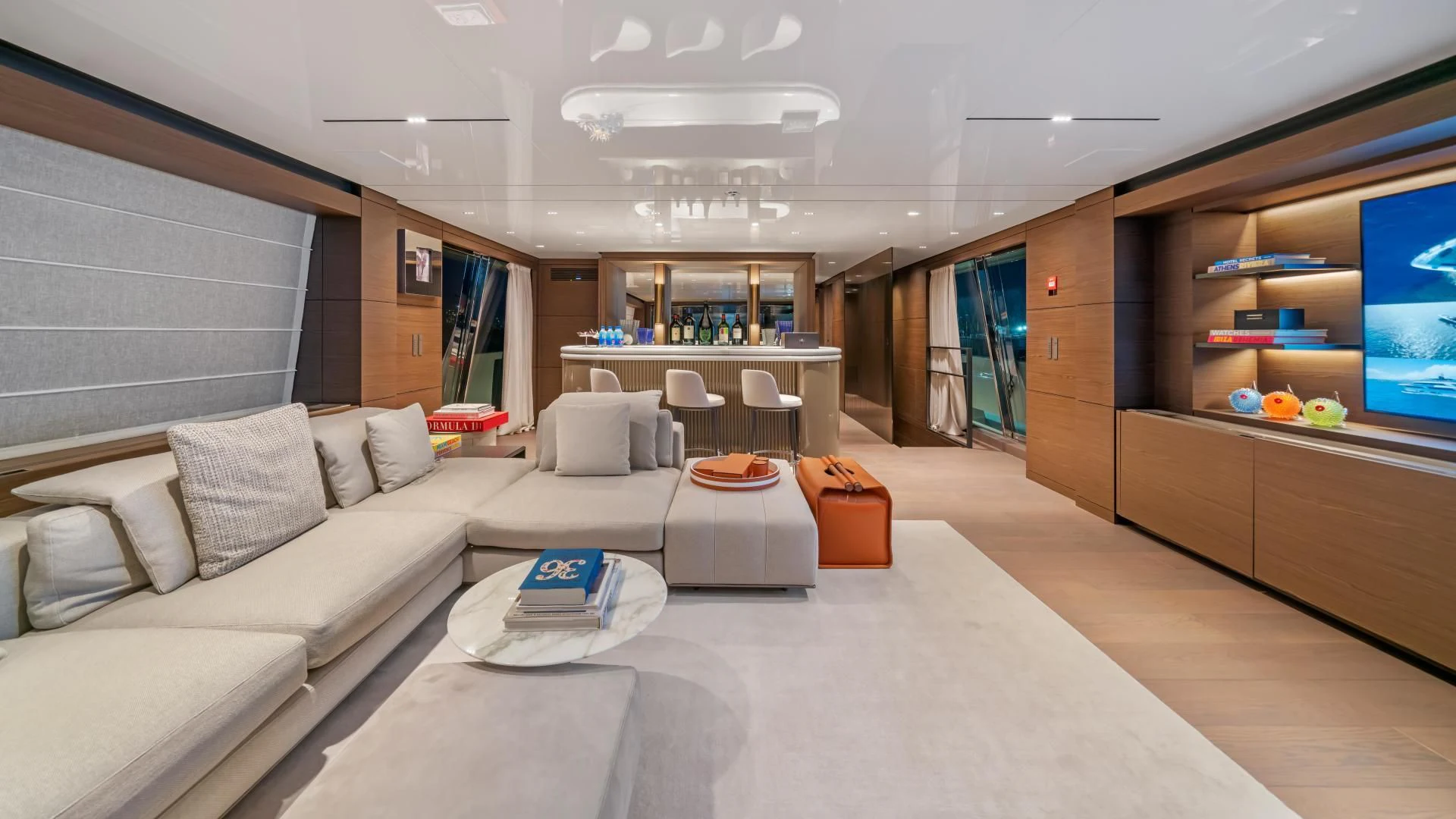 a living room with a large white sofa and a large window aboard ASANTE Yacht for Sale