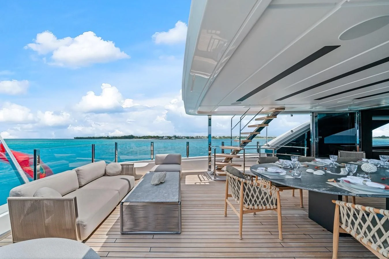 a deck with a table chairs and a large body of water aboard ASANTE Yacht for Sale