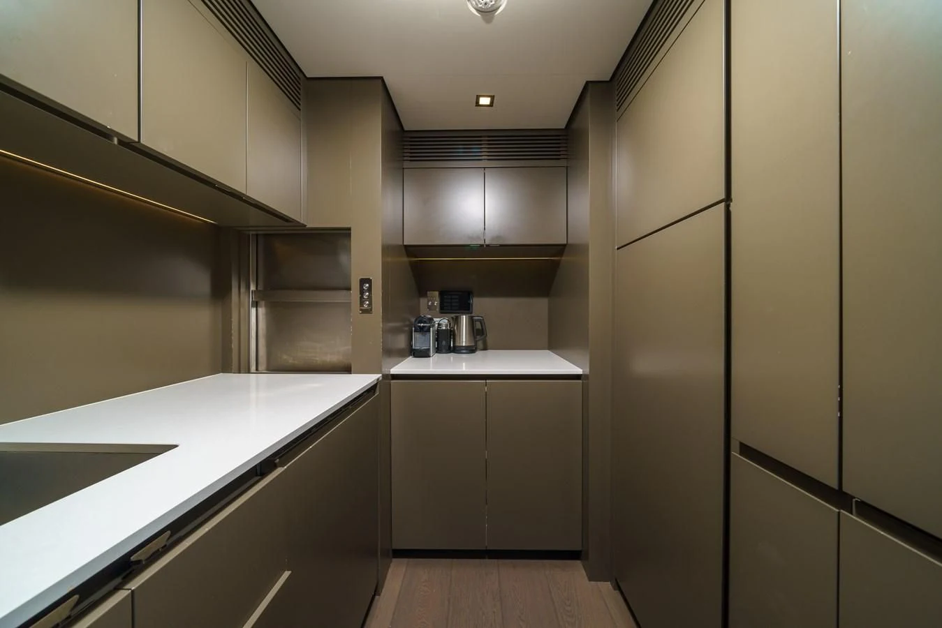 a kitchen with white cabinets aboard ASANTE Yacht for Sale