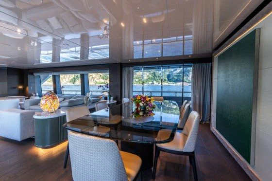 a large dining table in a room aboard ASANTE Yacht for Sale