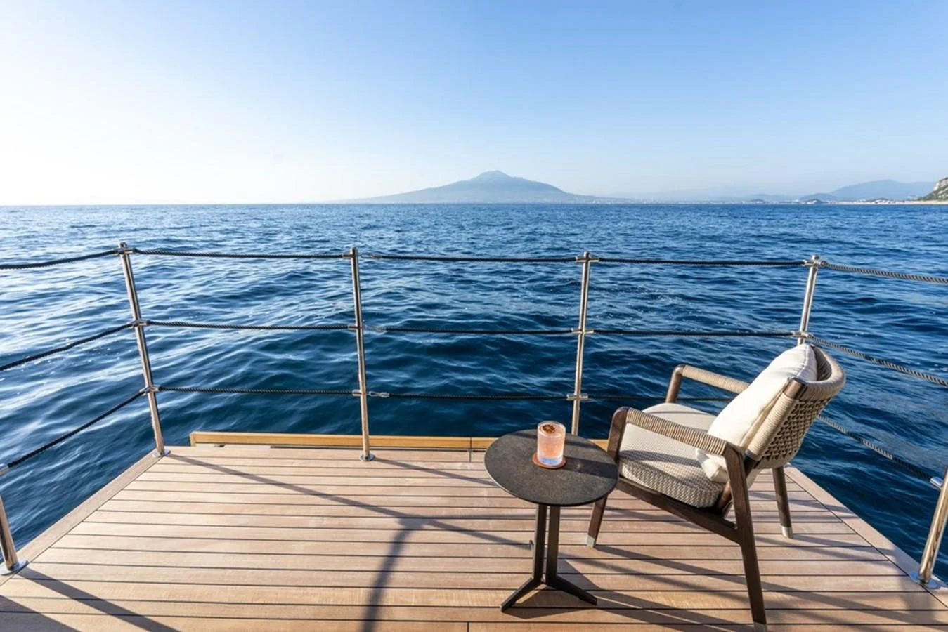 a chair on a dock overlooking the ocean aboard ASANTE Yacht for Sale
