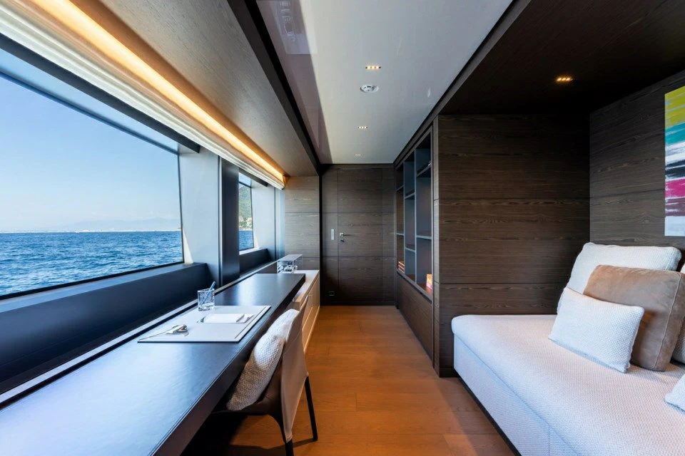 a room with a couch and a table and a window aboard ASANTE Yacht for Sale