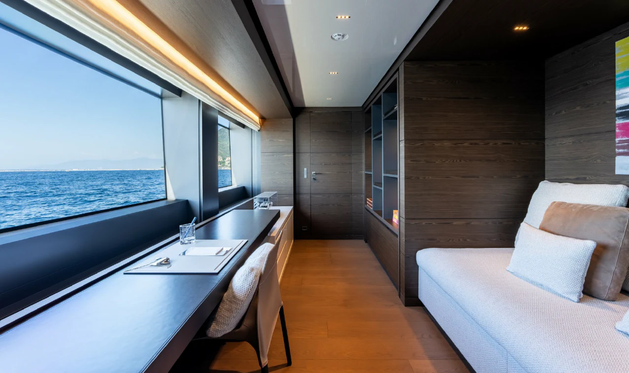 a room with a table and a couch and a window aboard ASANTE Yacht for Sale