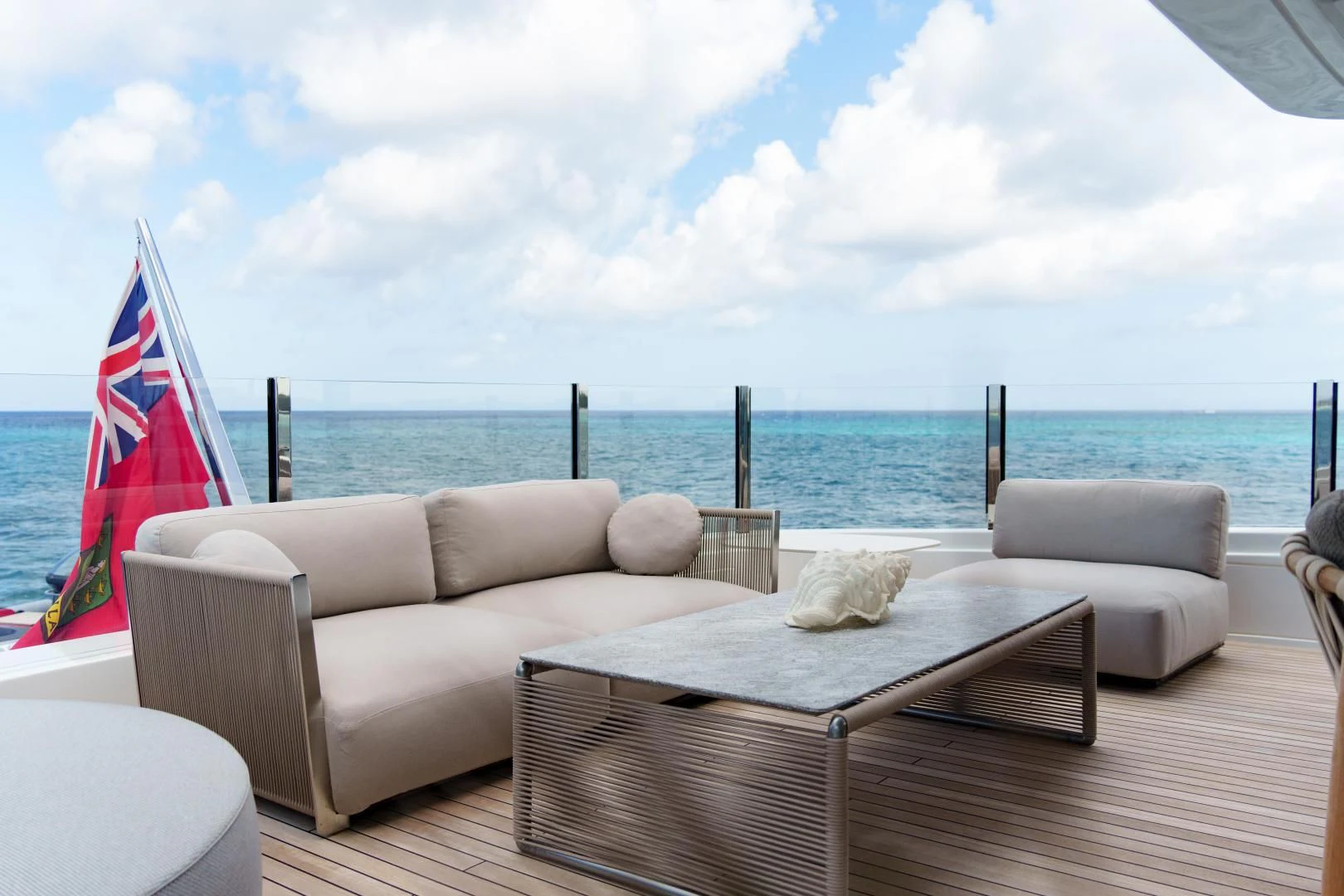 a patio with a table and chairs on it by the ocean aboard ASANTE Yacht for Sale