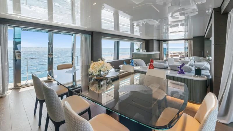 a large room with a table and chairs aboard ASANTE Yacht for Sale