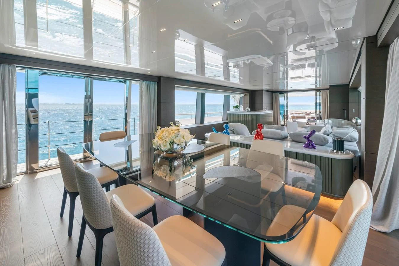 a large room with a table and chairs aboard ASANTE Yacht for Sale