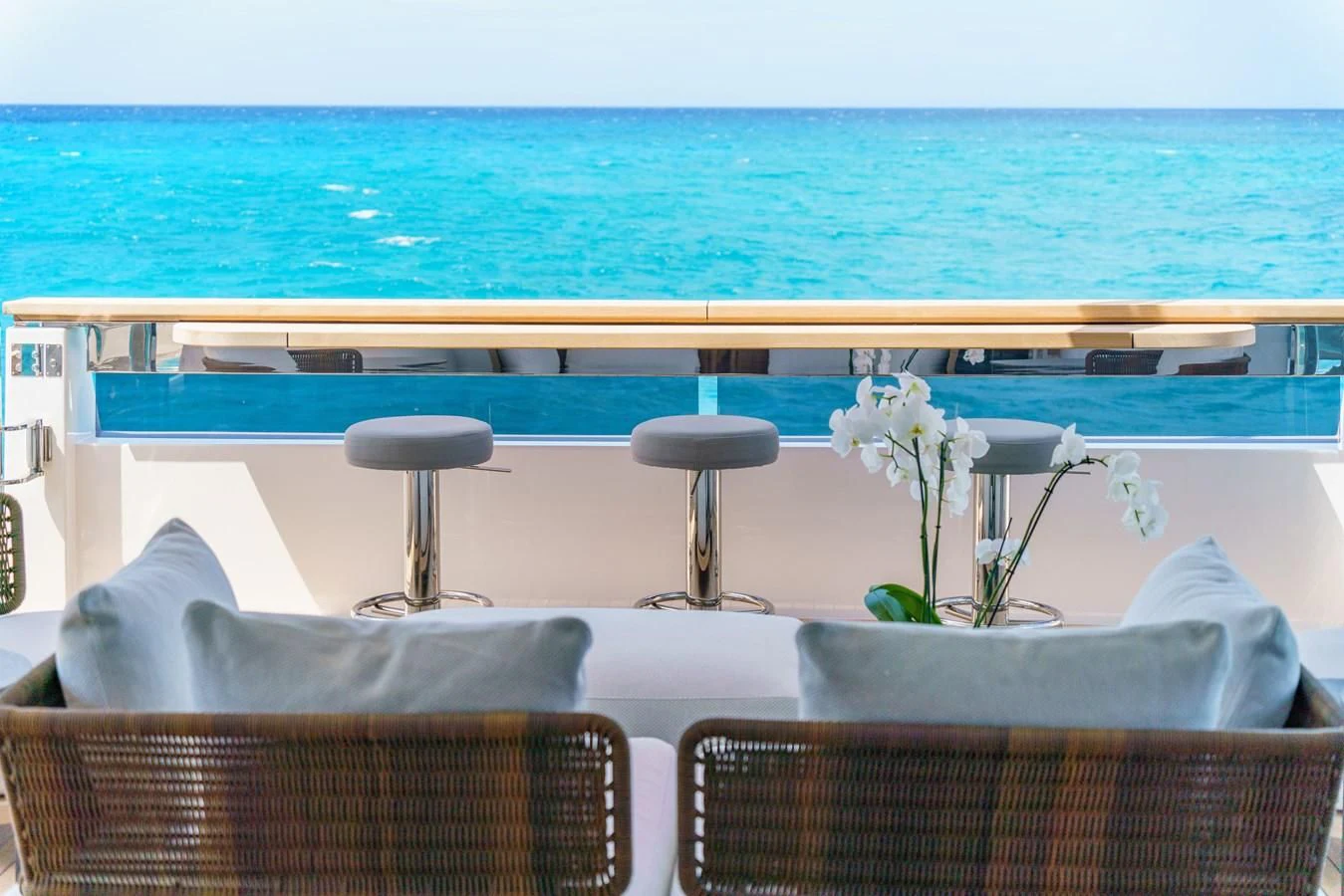 a table with chairs by the water aboard ASANTE Yacht for Sale