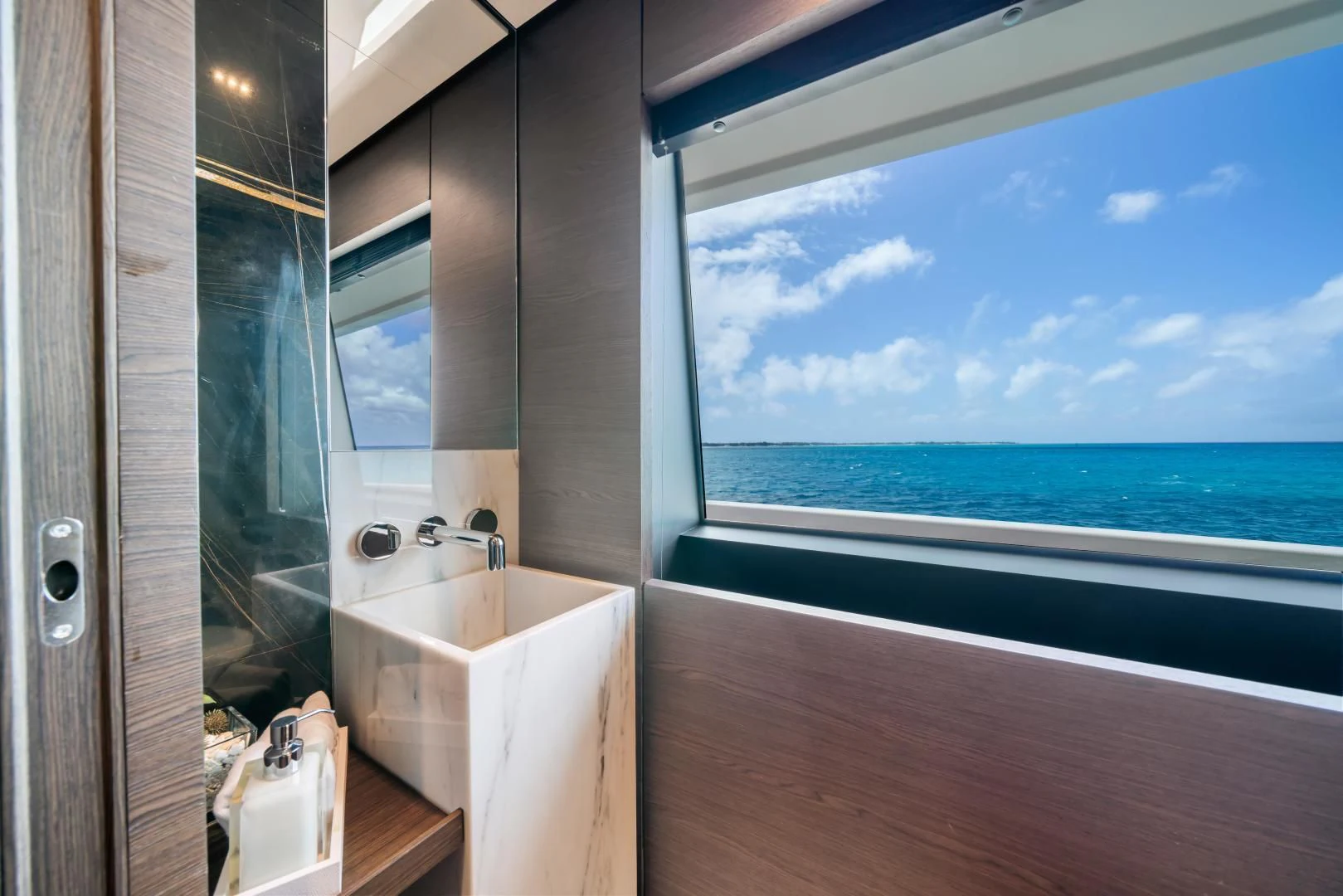 a bathroom with a large window overlooking the ocean aboard ASANTE Yacht for Sale
