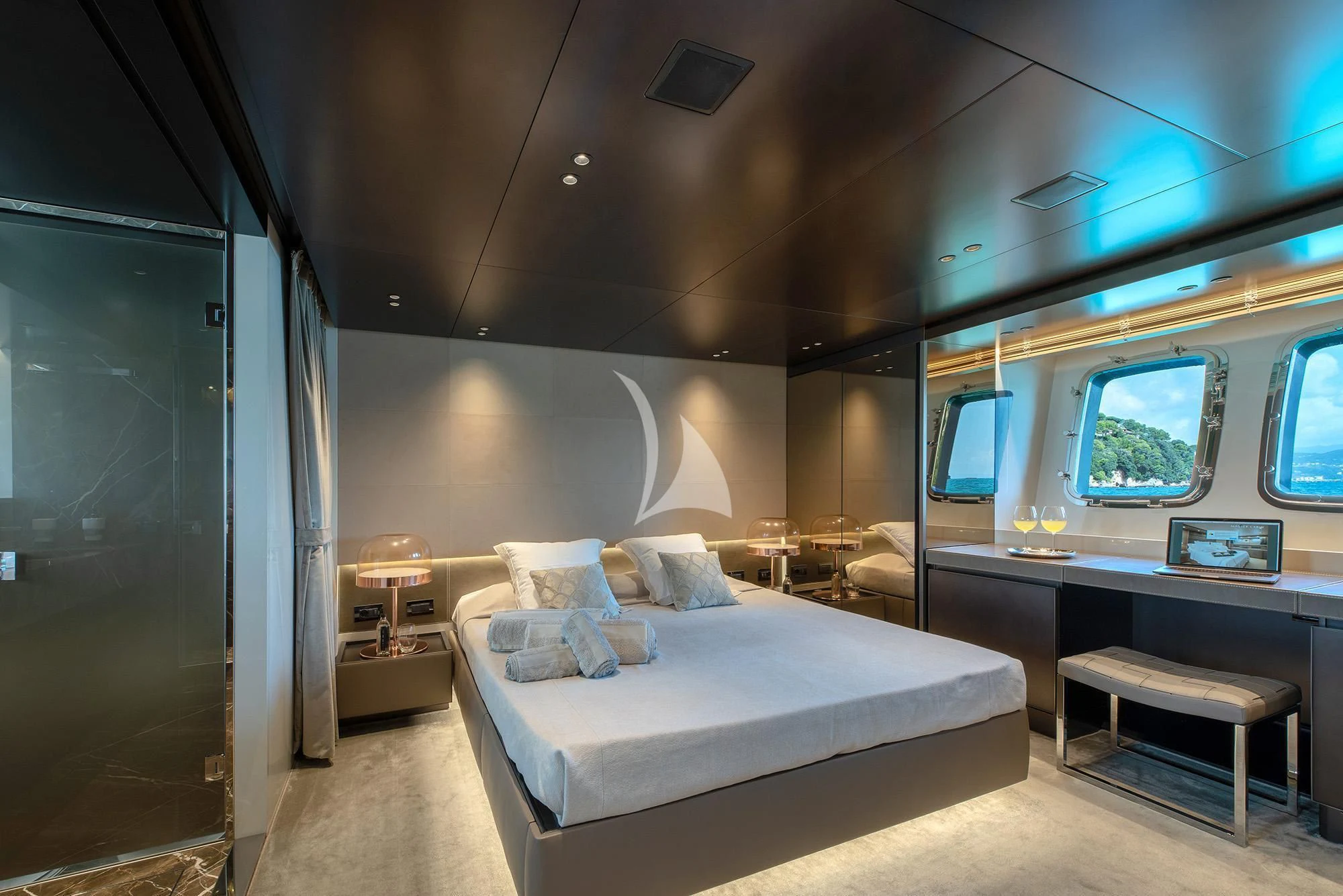 a bedroom with a bed and desk aboard TIBERIAS Yacht for Sale