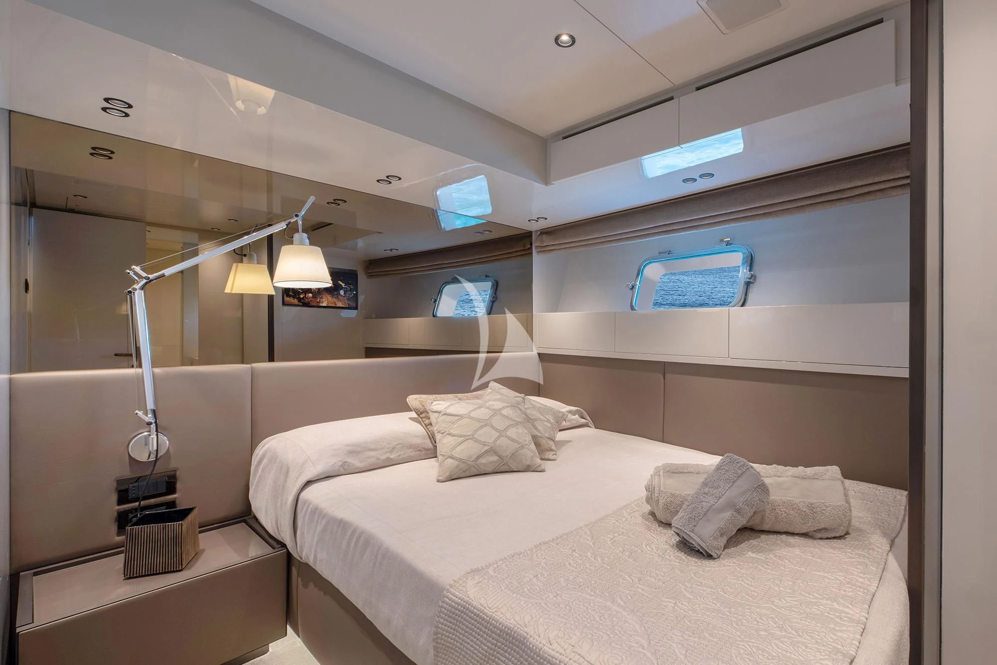 a bed with a lamp on the side aboard TIBERIAS Yacht for Sale