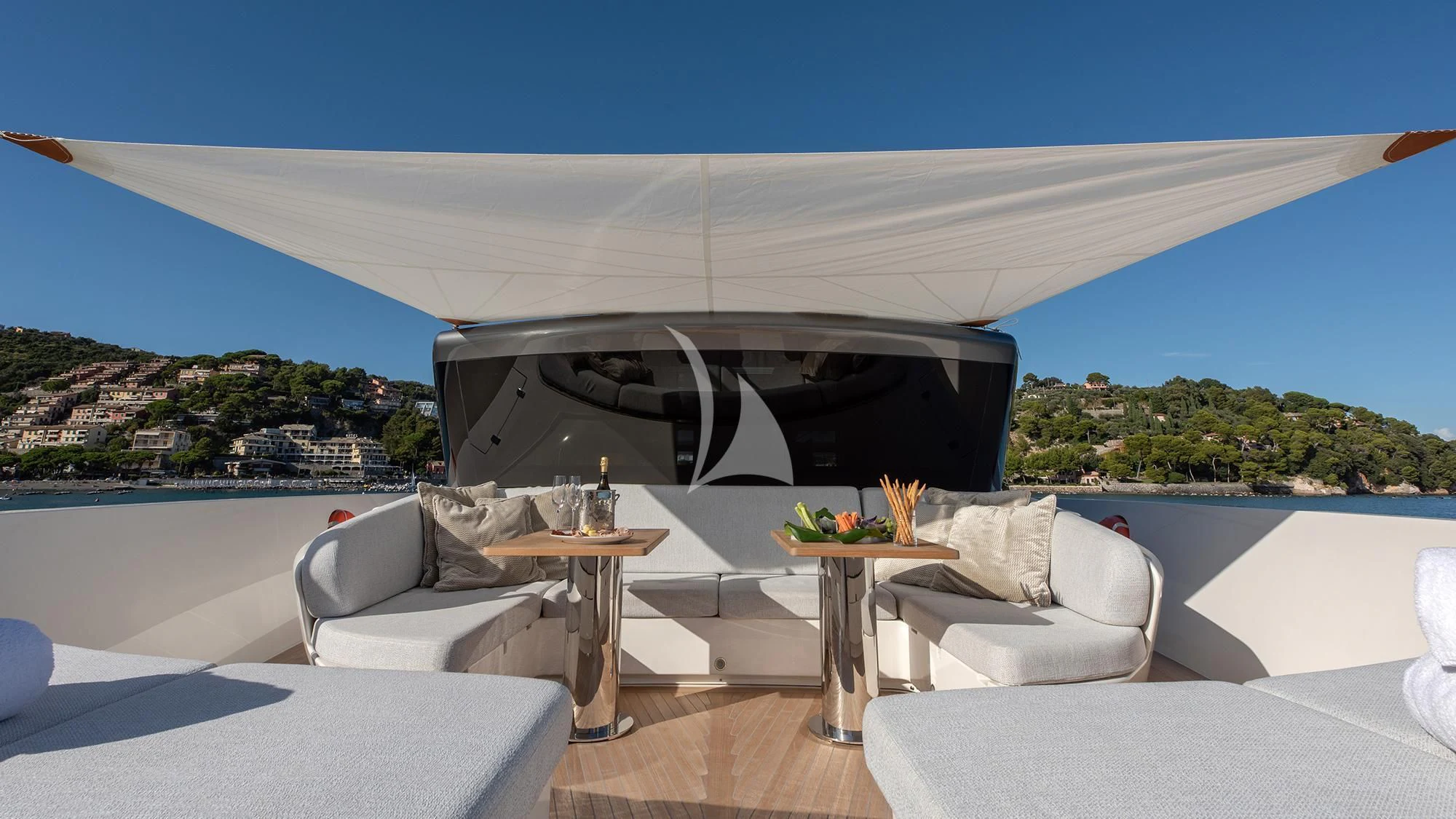 a room with a large white sofa and a table and chairs aboard TIBERIAS Yacht for Sale