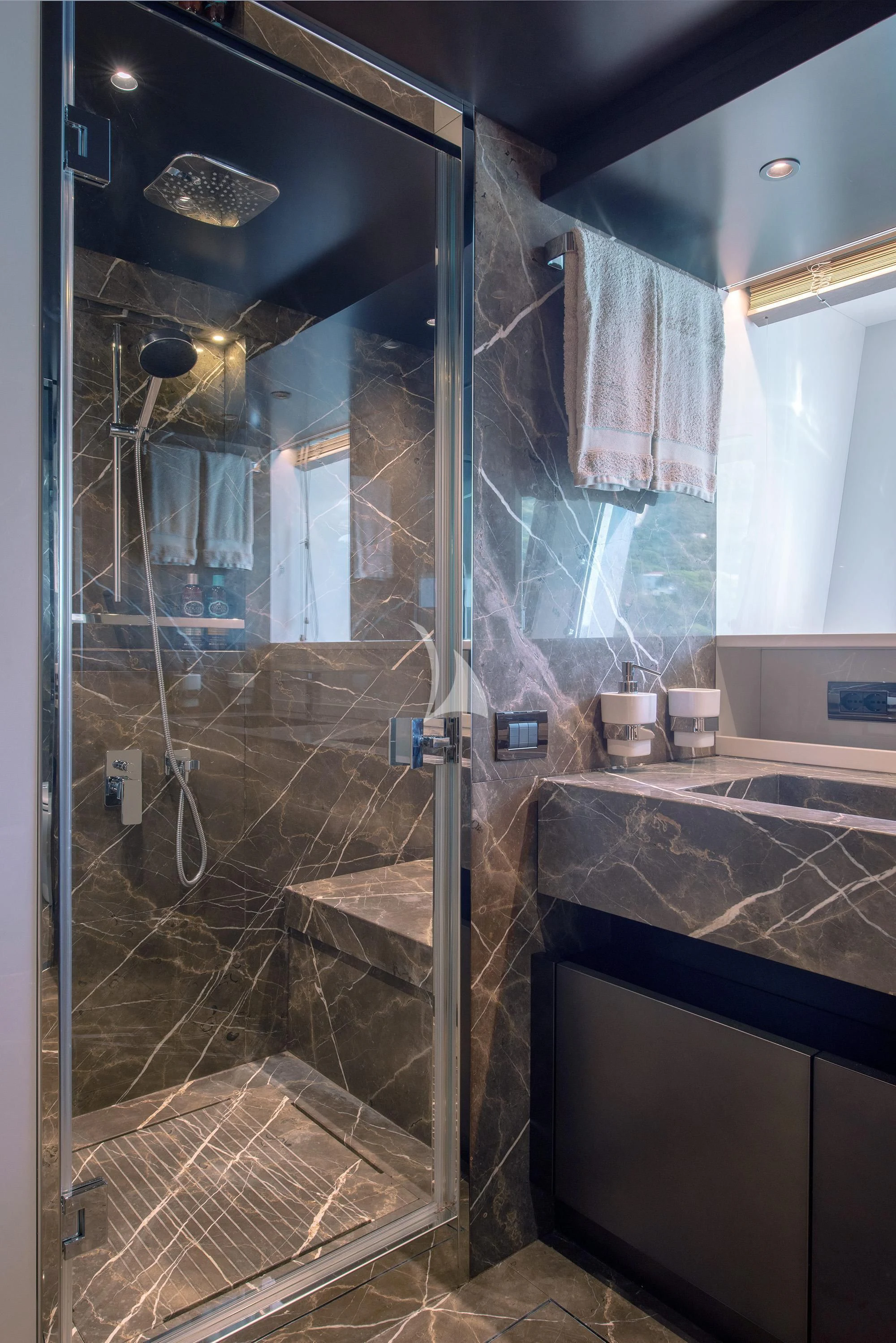 a bathroom with a glass shower aboard TIBERIAS Yacht for Sale