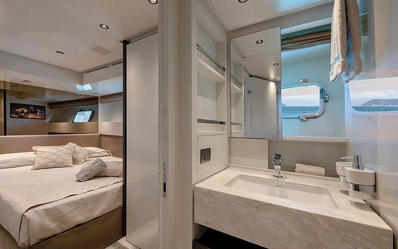 a bathroom with a sink and a bed aboard TIBERIAS Yacht for Sale