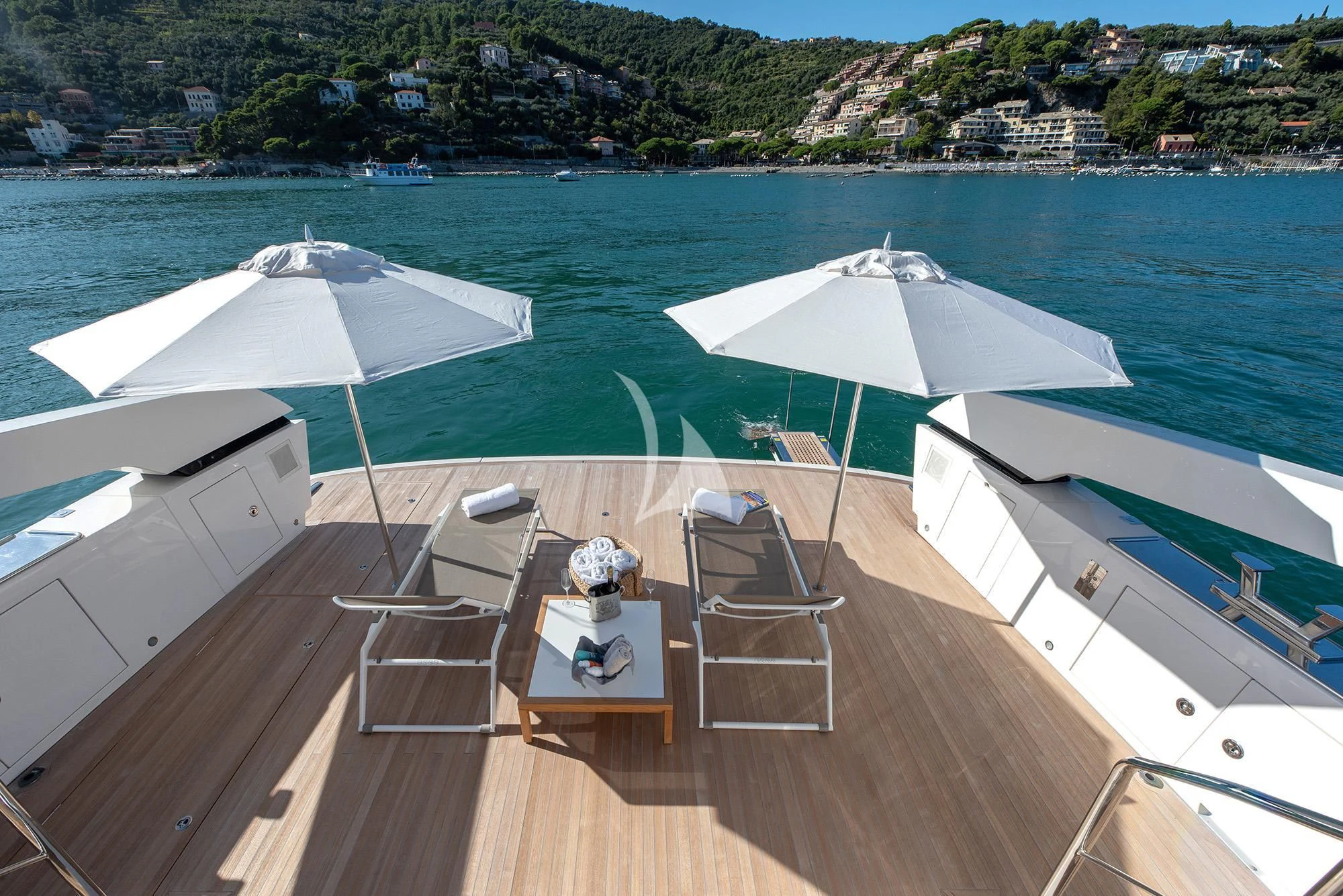a deck with chairs and umbrellas on it aboard TIBERIAS Yacht for Sale