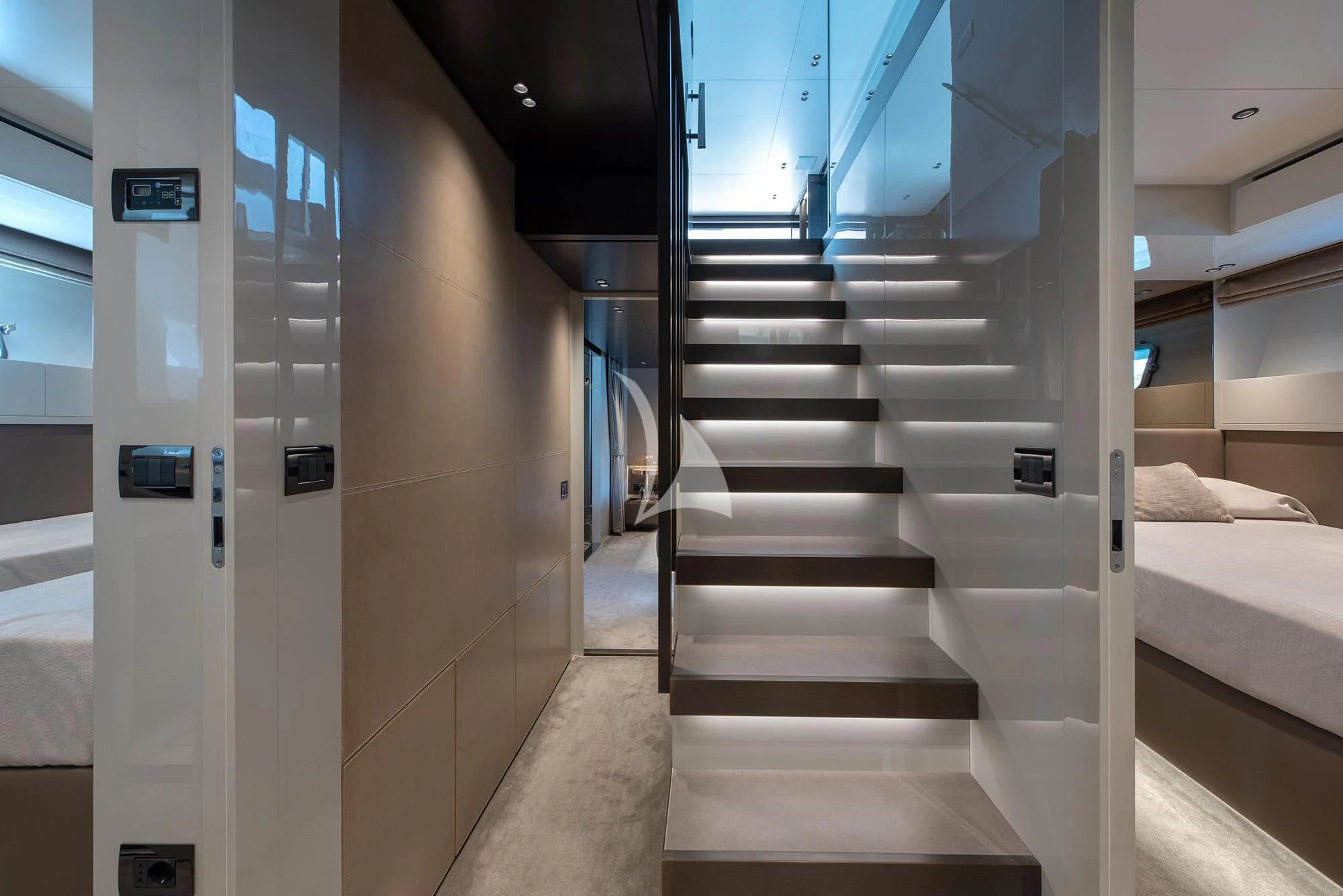 a hallway with a bed and a couch aboard TIBERIAS Yacht for Sale
