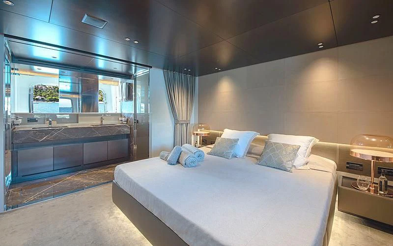 a large bedroom with a large bed aboard TIBERIAS Yacht for Sale