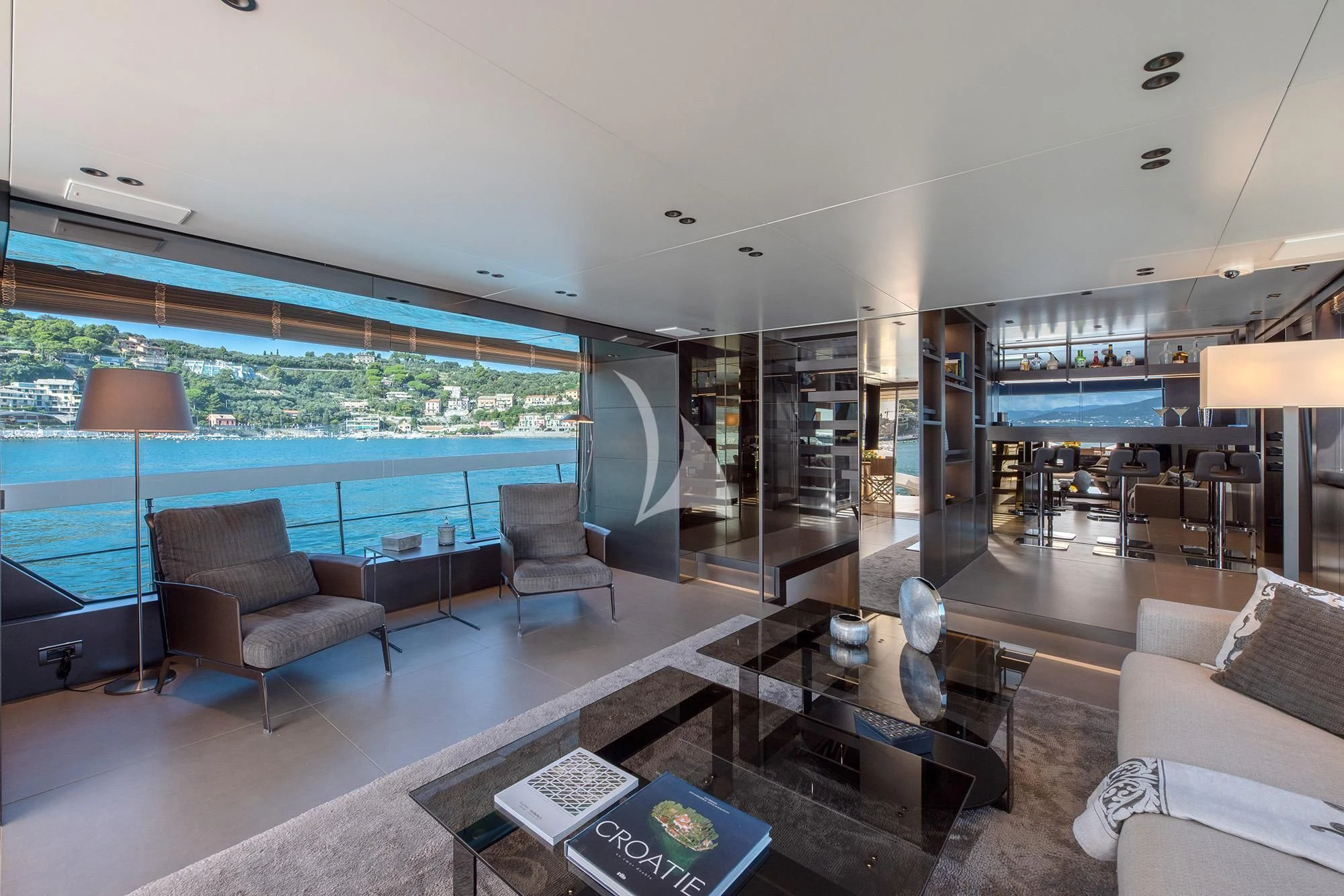 a living room with a large screen aboard TIBERIAS Yacht for Sale