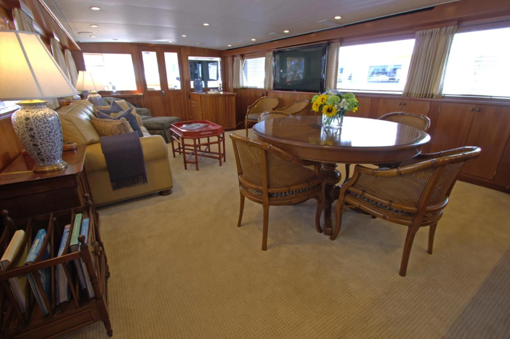 a living room with a table and chairs aboard LORELEI Yacht for Sale