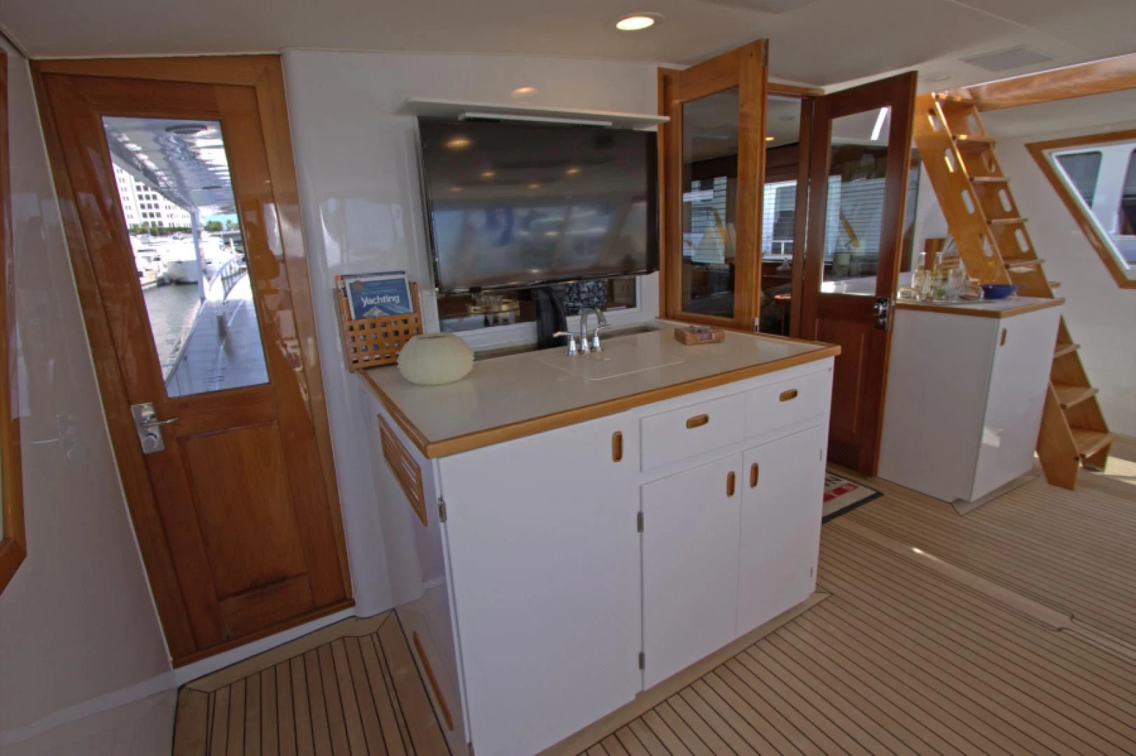 a kitchen with white cabinets aboard LORELEI Yacht for Sale