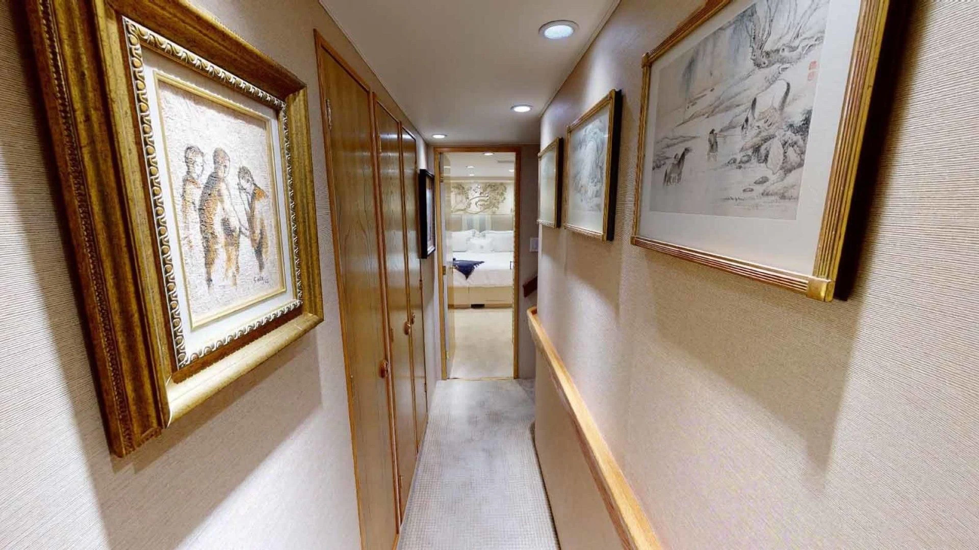 a hallway with paintings on the wall aboard LORELEI Yacht for Sale