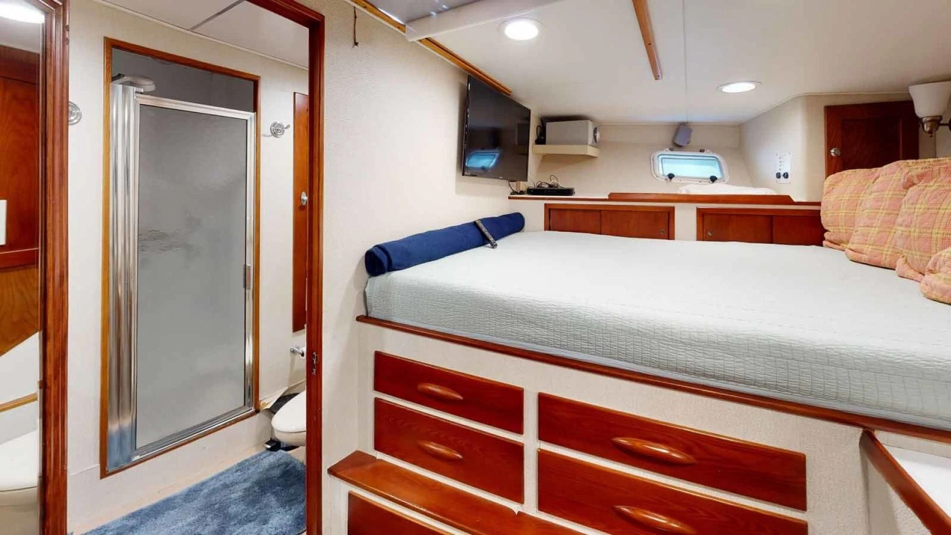 a bedroom with a bed and a desk aboard LORELEI Yacht for Sale