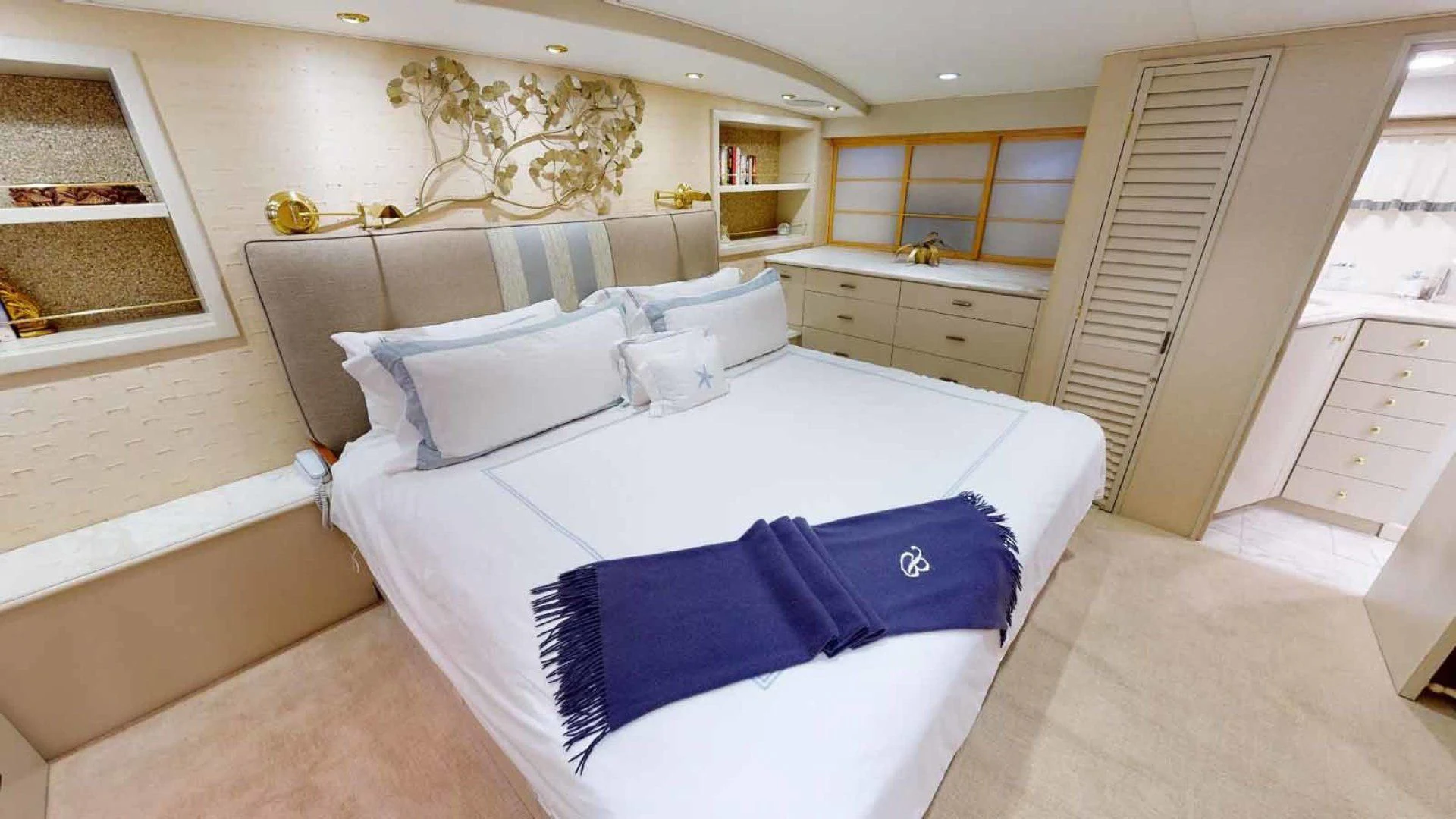 a bedroom with a bed and a desk aboard LORELEI Yacht for Sale
