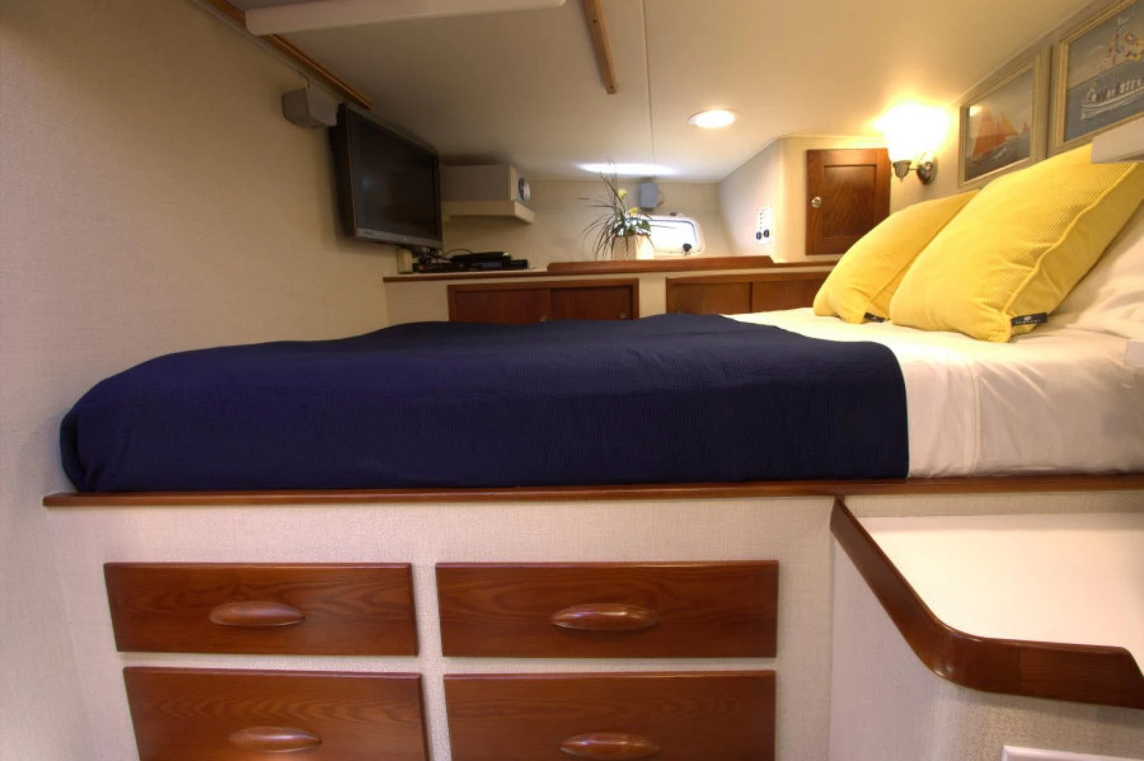 a bed with a blue sheet aboard LORELEI Yacht for Sale