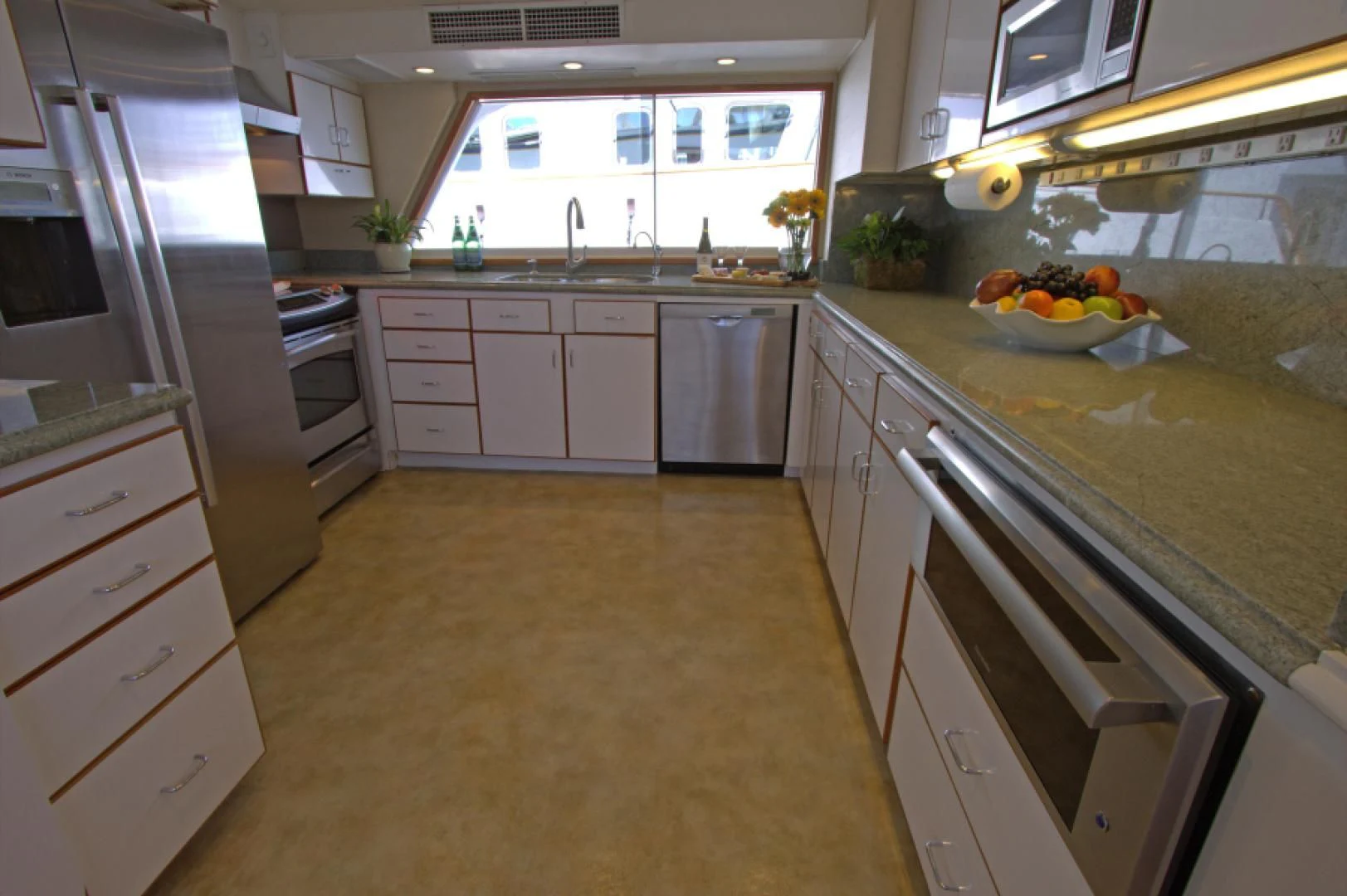 a kitchen with white cabinets aboard LORELEI Yacht for Sale