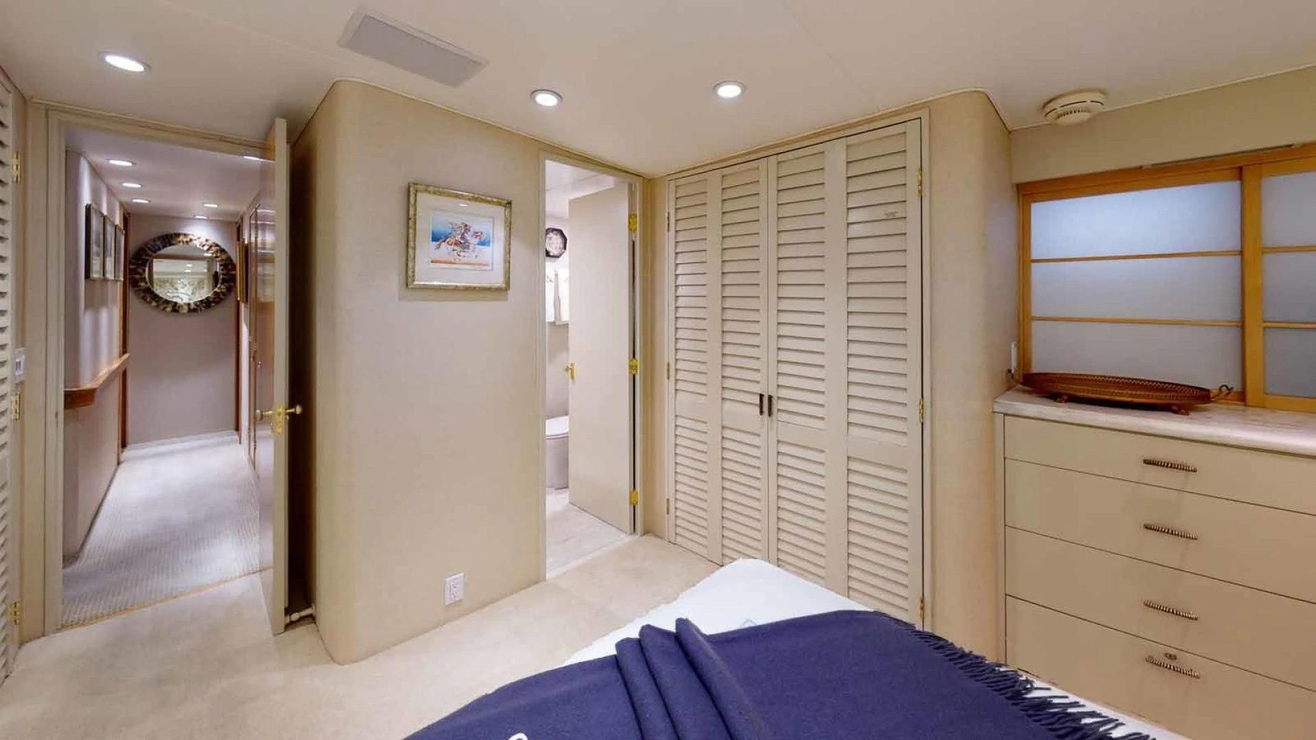 a bedroom with a bed and a mirror aboard LORELEI Yacht for Sale