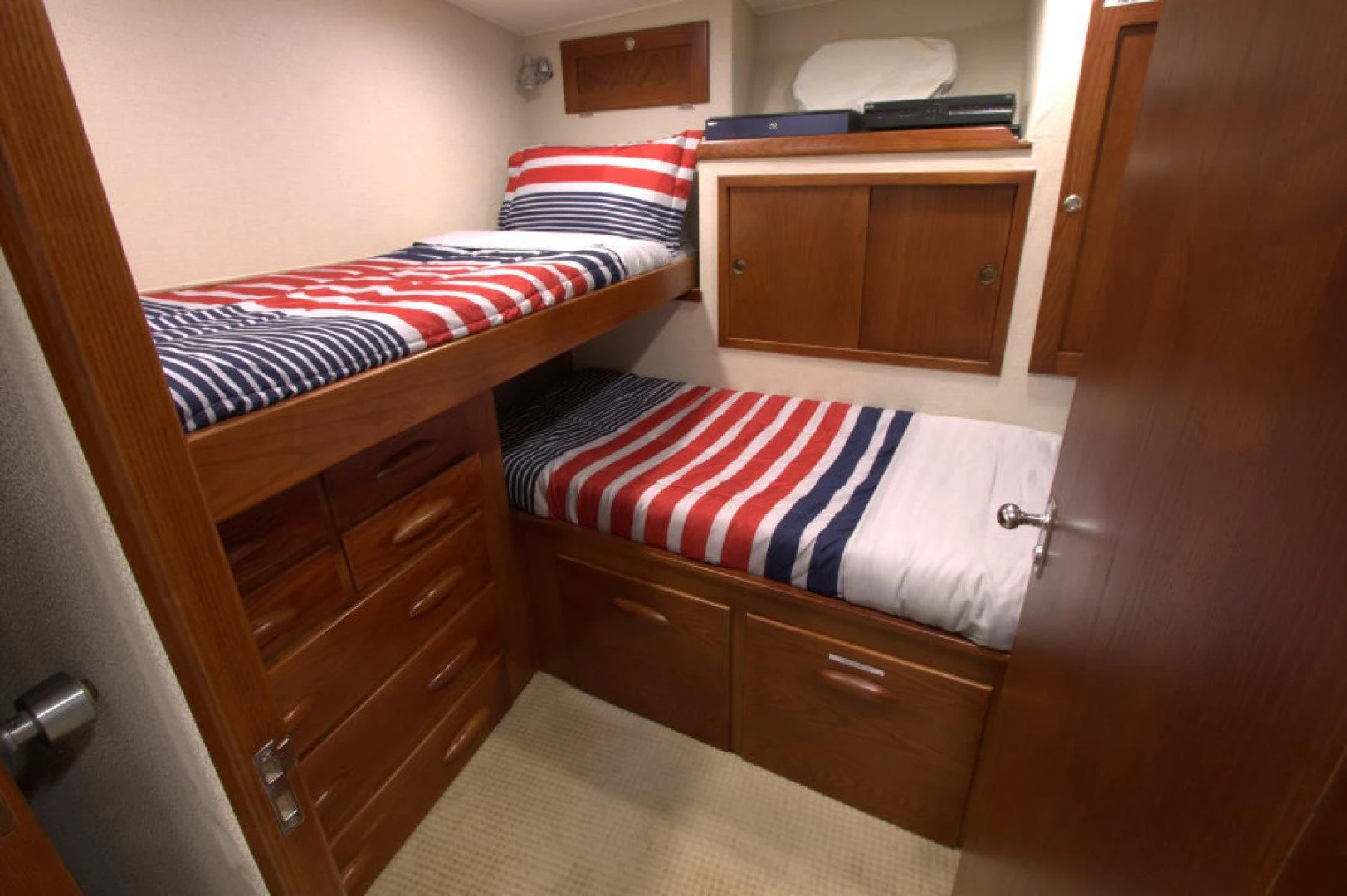 a bed with a striped blanket aboard LORELEI Yacht for Sale